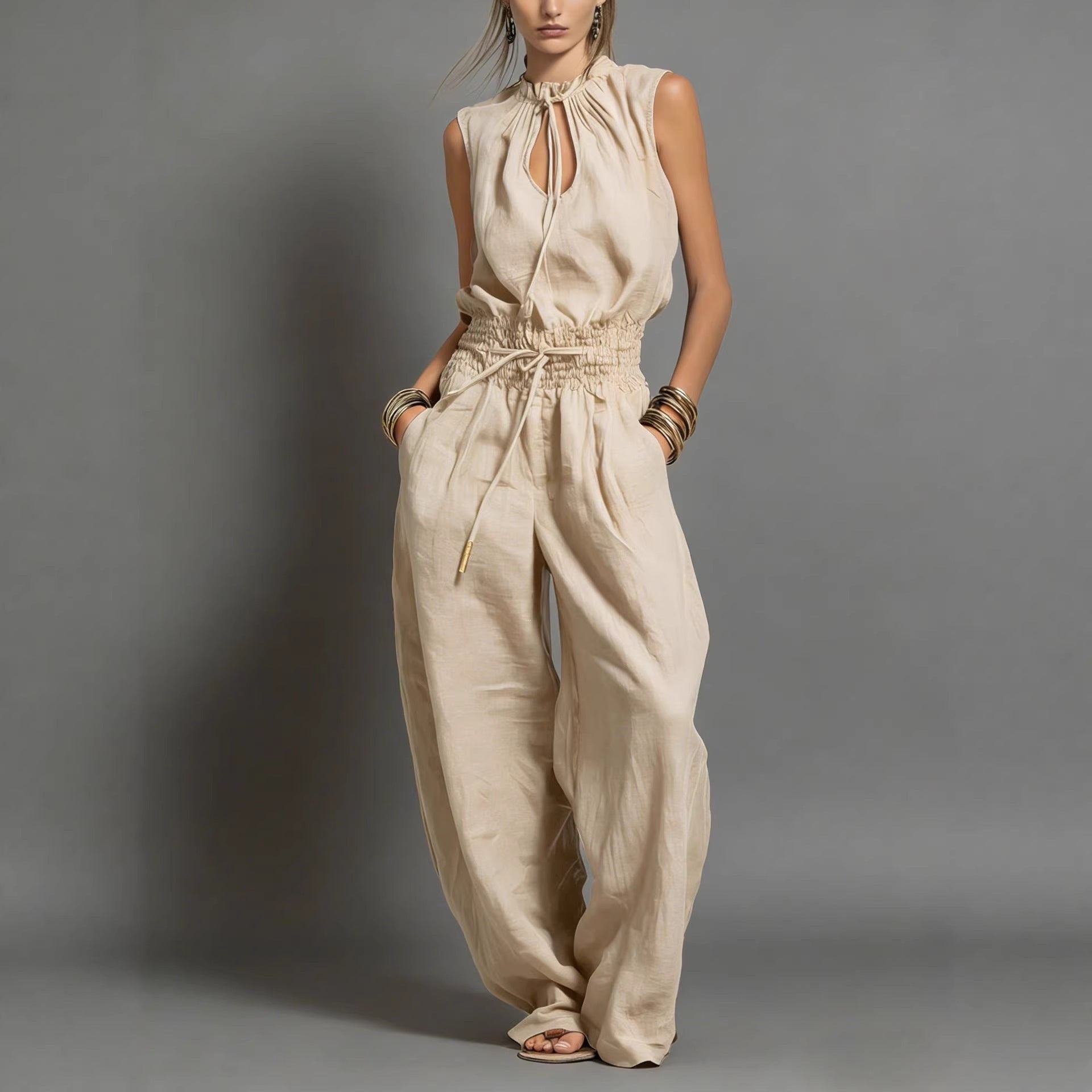 Women's sleeveless high-waist wide-leg pleated jumpsuit from FitiqueFit, shown in a casualwear style with flowing fabric and elegant design.