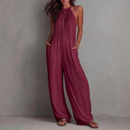 Women's sleeveless open-back wide-leg pleated jumpsuit from FitiqueFit, featuring a casual style with flowing fabric and stylish design.
