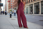 Women’s sleeveless open-back wide-leg pleated jumpsuit by FitiqueFit, casualwear with flowing fabric and stylish design.