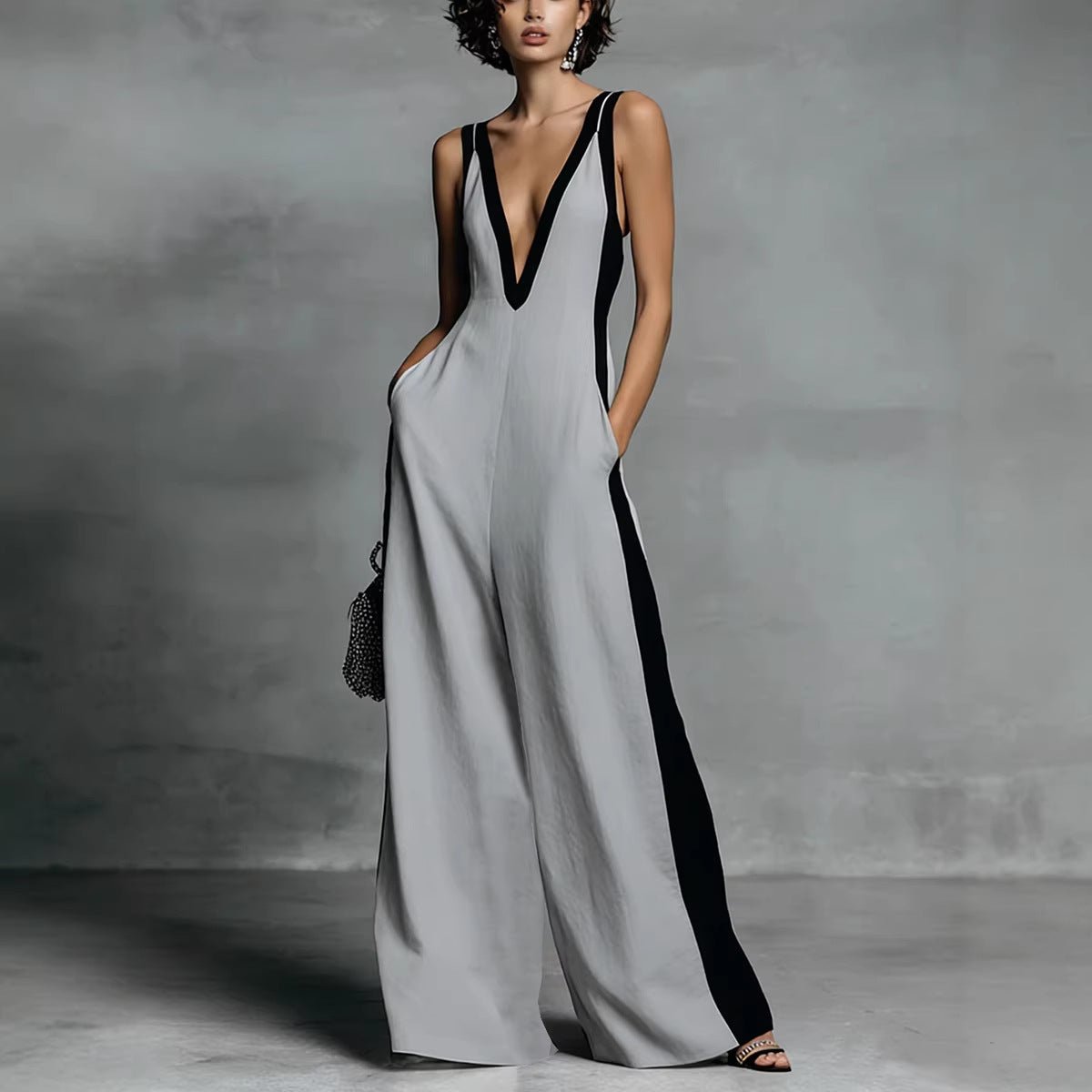 Women’s sleeveless V-neck contrast color wide-leg jumpsuit by FitiqueFit, showcasing its stylish design and flowing fabric.