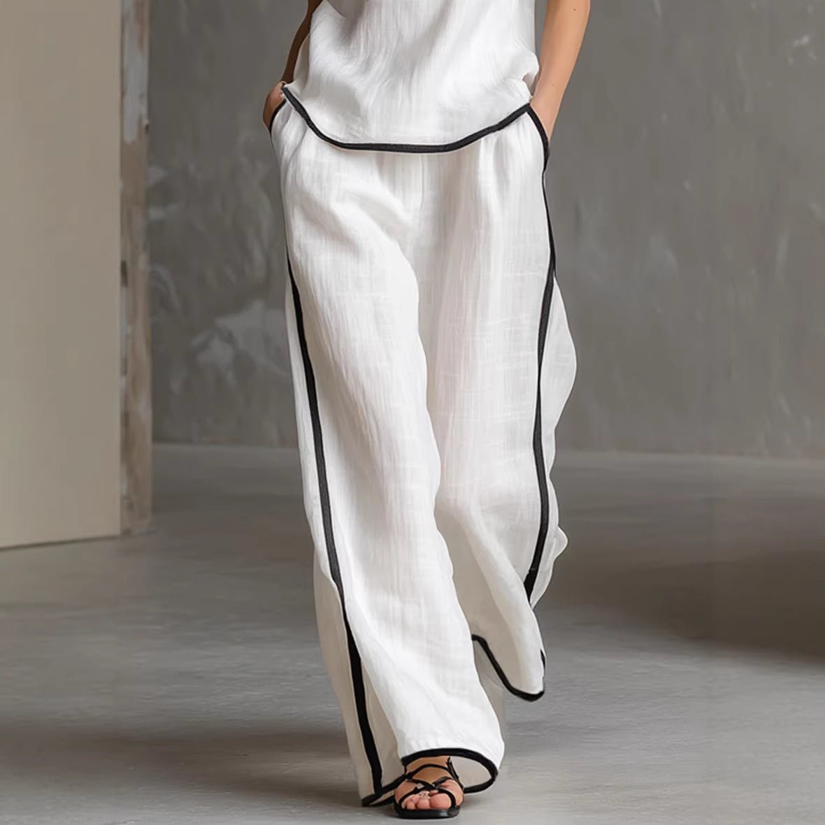 Women’s sleeveless V-neck wide-leg pants set by FitiqueFit, casualwear featuring a stylish sleeveless top and flowy wide-leg trousers.