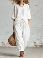 Women's solid color casual set by FitiqueFit, includes a loose T-shirt and ankle pants, perfect for comfortable everyday wear.