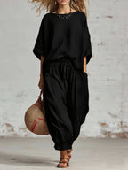 Women's solid color loose casual set with T-shirt and ankle pants by FitiqueFit, displayed on a model.