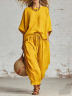 Women's solid color casual set with loose T-shirt and ankle pants from FitiqueFit, shown in relaxed fit and comfortable style.