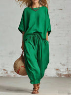 Women’s solid color loose casual set with T-shirt and ankle pants by FitiqueFit, displayed on a model.