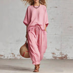 Women's solid color casual set with a loose T-shirt and ankle pants from FitiqueFit, displayed on a model.