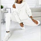 Women’s solid color three-piece casualwear set by FitiqueFit, featuring a coordinated top, pants, and jacket in a neutral shade.