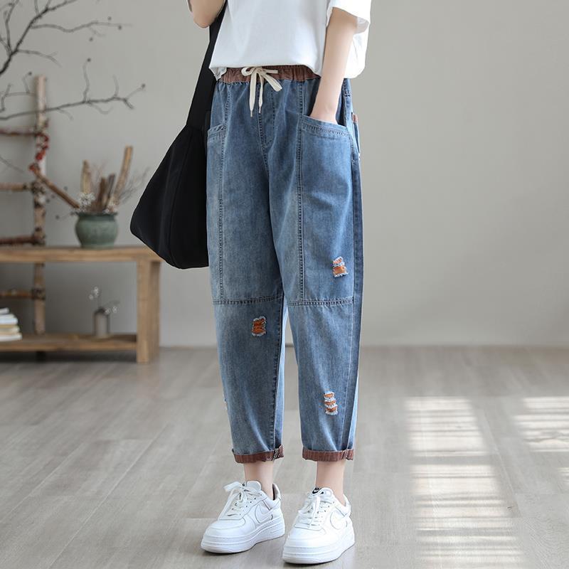 Women's summer streetwear ripped Ninth Jeans by FitiqueFit, showcasing distressed denim with frayed hems and stylish fit.