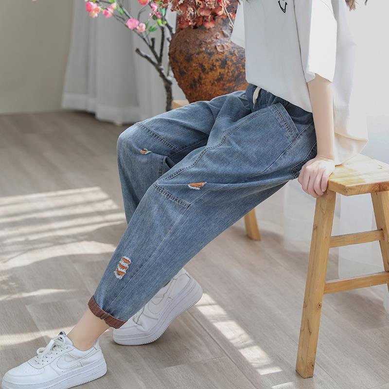 Women's summer streetwear ripped Ninth jeans by FitiqueFit, featuring distressed details and a trendy casual style.