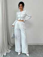 Women’s tweed pearl-button jacket and pants set by FitiqueFit, casualwear ensemble featuring textured fabric and elegant buttons.