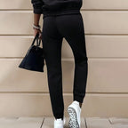 Women's two-piece solid color hooded sweatshirt set by FitiqueFit, featuring a comfortable casualwear style with a hooded top and matching pants.