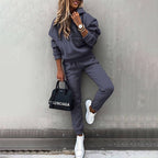 Women's two-piece solid color hooded sweatshirt set by FitiqueFit, featuring a casual, comfortable style with a matching hoodie and pants.