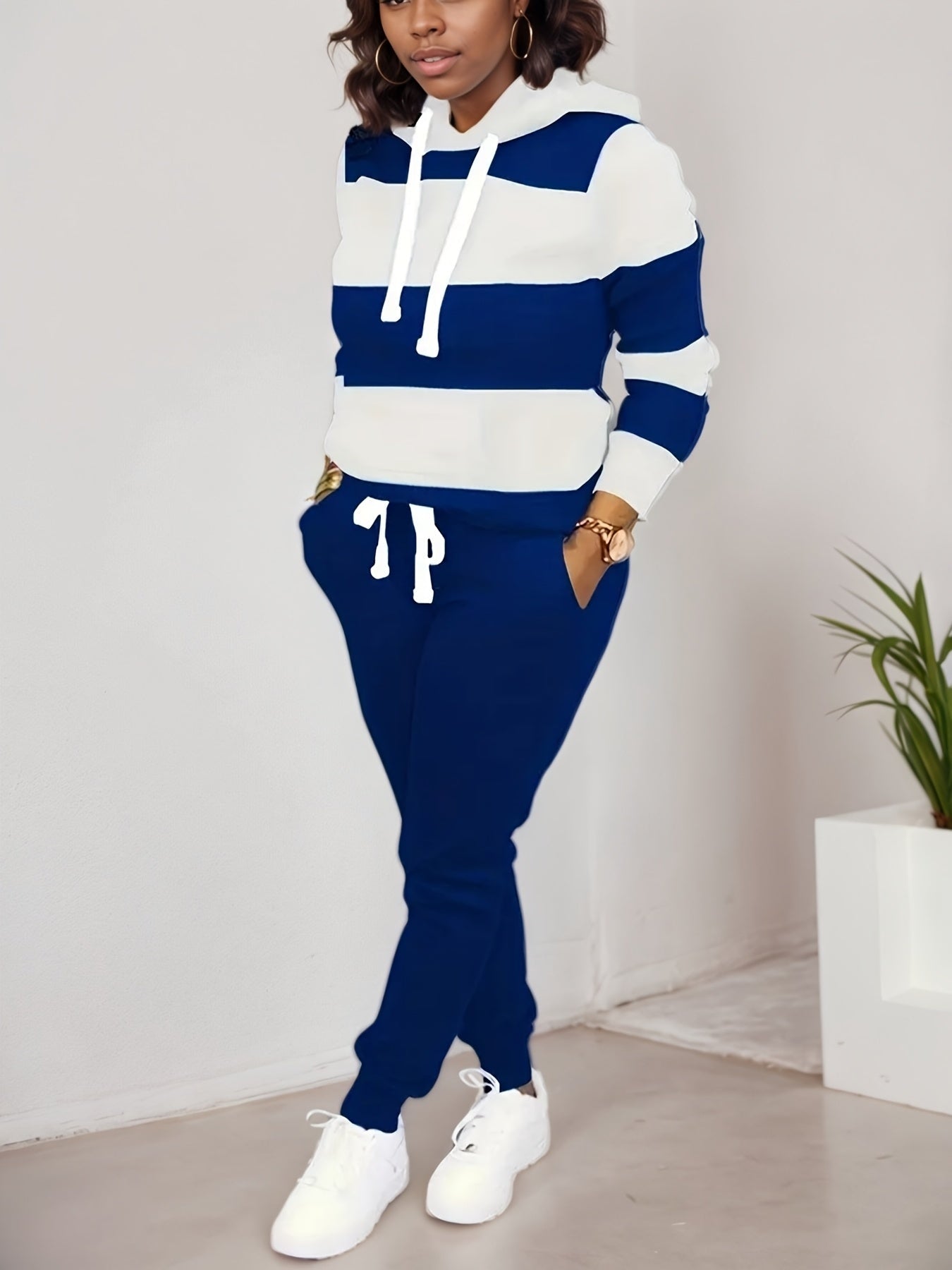 Women’s two-piece casual sportswear set by FitiqueFit featuring a sweatshirt and matching pants, perfect for comfortable everyday wear.