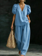 Women's V-neck casual two-piece set by FitiqueFit, featuring a relaxed fit top and matching pants in soft fabric.