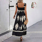 Women’s wide-strap printed maxi dress by FitiqueFit, casualwear with colorful floral pattern and flowing fabric.