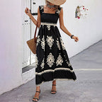 Women’s wide-strap printed maxi dress by FitiqueFit, casualwear with a flowing, colorful floral pattern.