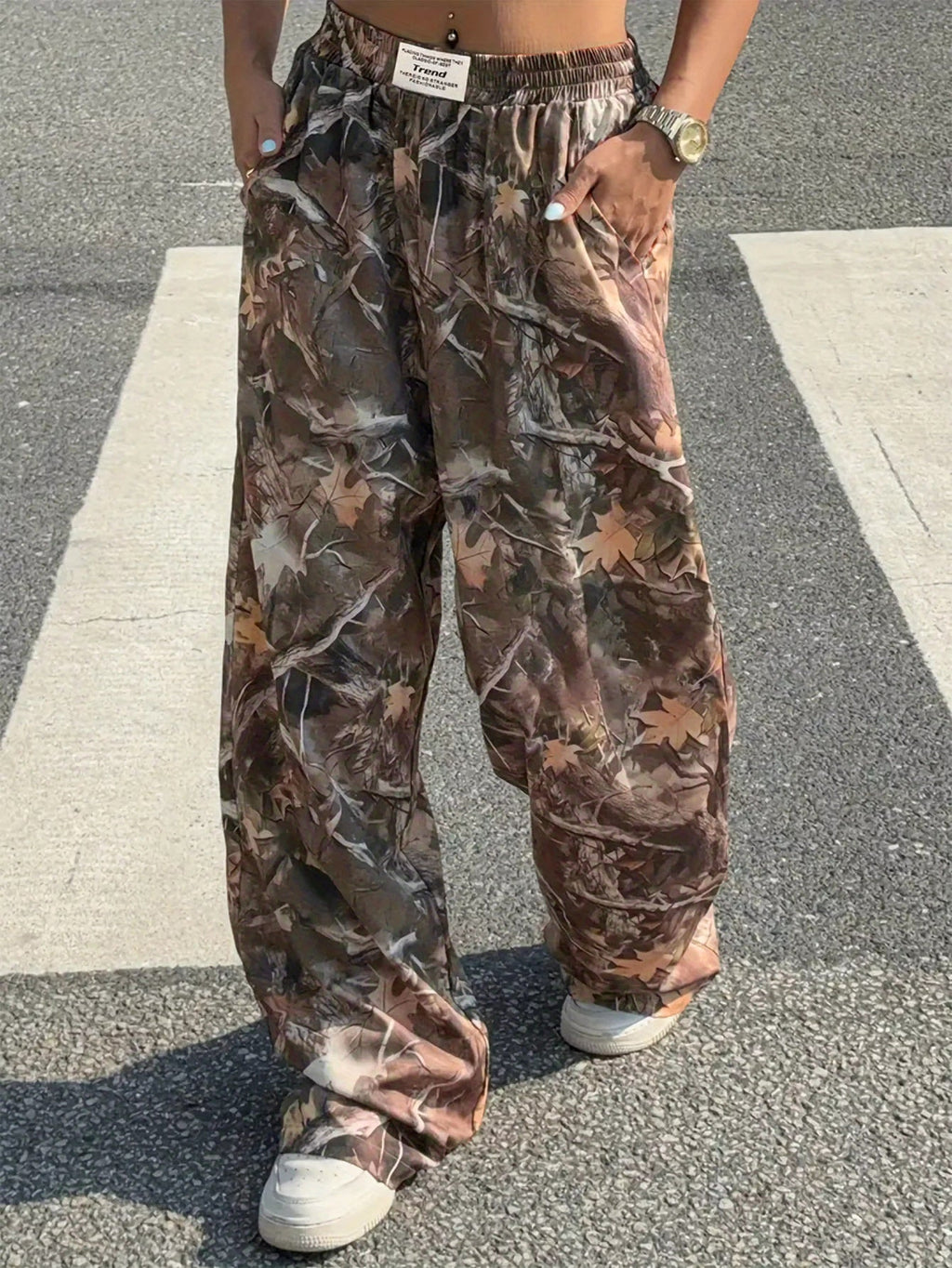 Women's Y2K camouflage cargo pants by FitiqueFit featuring a casual wear style with green and black camouflage print.