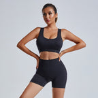Women's FitiqueFit yoga set with a sleeveless vest and matching shorts, designed for activewear and workout comfort.