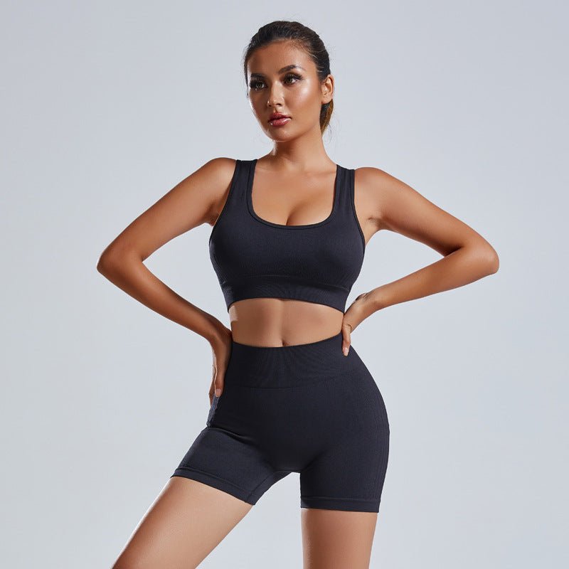 Women's FitiqueFit yoga set with a sleeveless vest and matching shorts, designed for activewear and workout comfort.